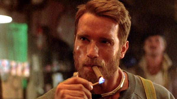 The Running Man - Arnold Schwarzenegger as Ben Richards lighting up a cigar and smoking a cigar