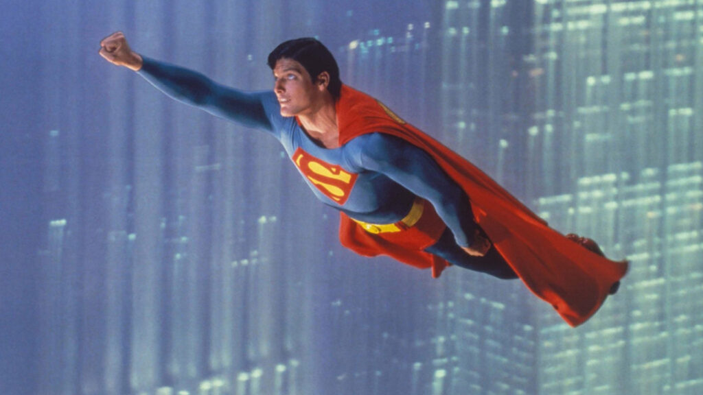 Christopher Reeve's Superman looks determinedly ahead as he flies through the city of Metropolis.