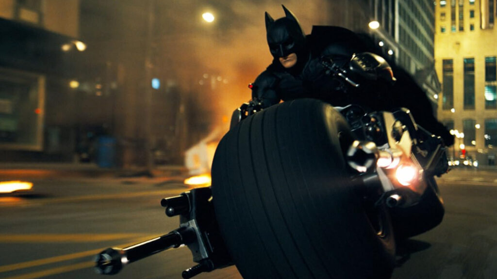 Christian Bale's Batman riding the Batpod through the streets of Gotham City.