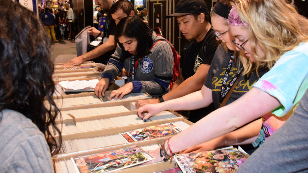 Comics fans looking through boxes of comic books at San Diego Comic Con.