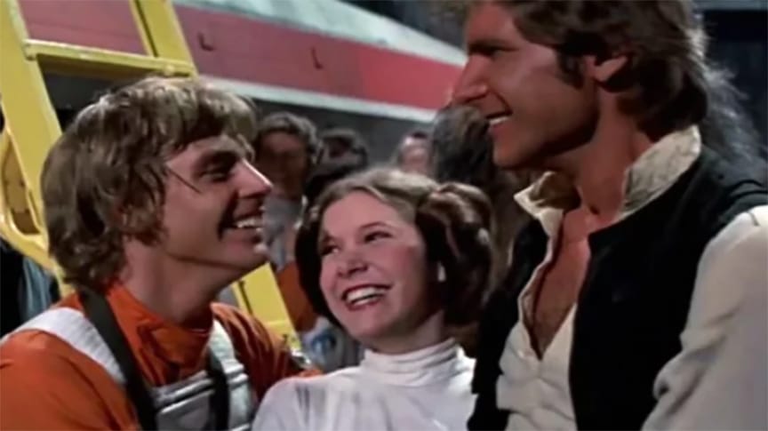 Luke Skywalker, Princess Leia and Han Solo celebrating the destruction of the Death Star in A New Hope.