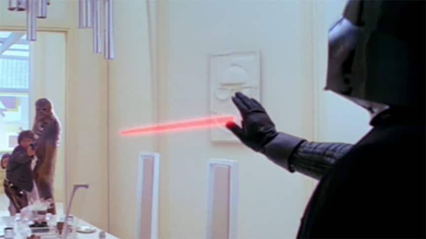 Darth Vader freezes a blaster bolt from Han Solo after surprising the smuggler on Cloud City.