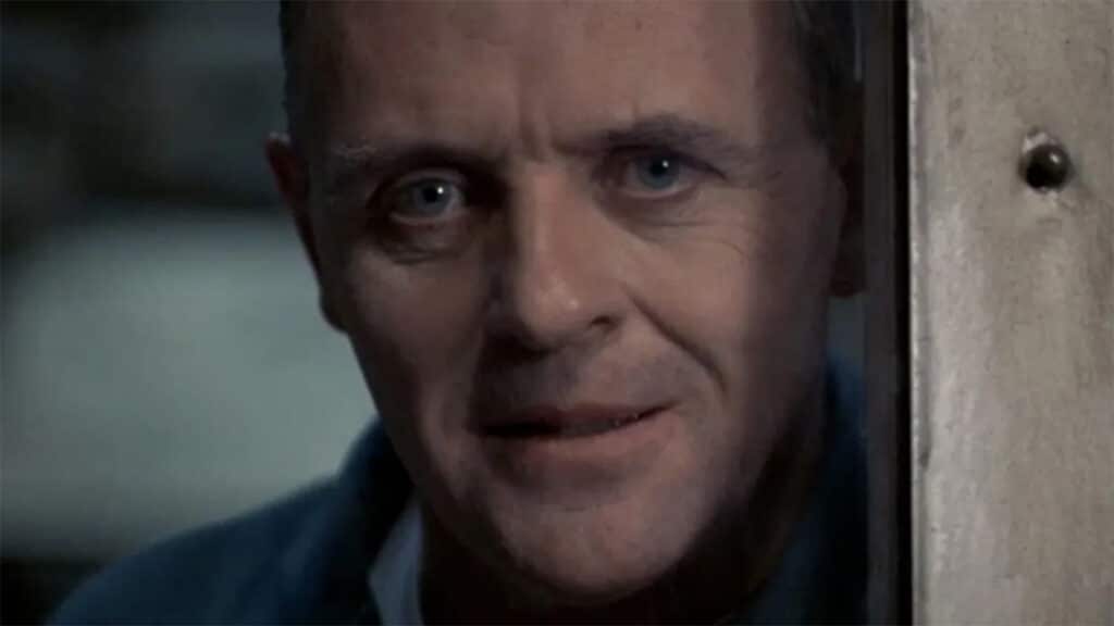 Dr. Hannibal Lecter looking deep into Clarice Starling's eyes from behind the window of his prison.