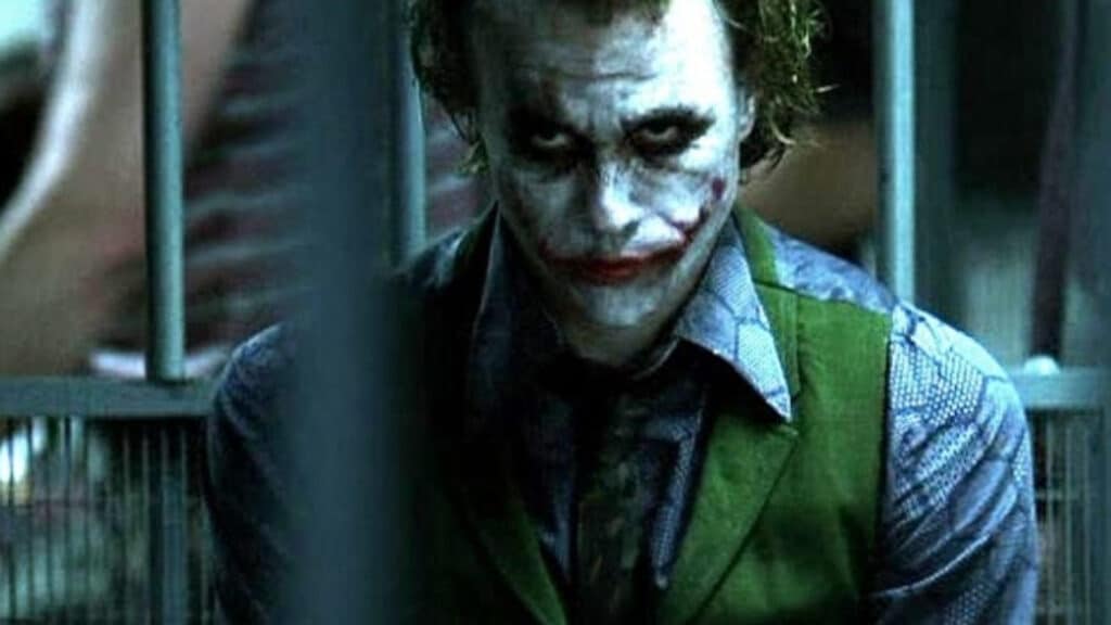 Heath Ledger's The Joker from The Dark Knight, stares from his prison cell, waiting for his plan to come to fruition.