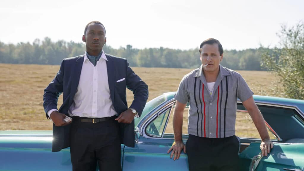 Screenshot from Green Book, one of the more debated movies that aged badly, featuring Tony Vallelonga driving with Don Shirley seated beside him inside a car.