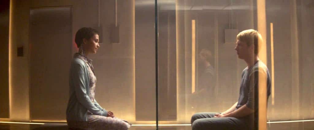 Ava from Ex Machina standing behind glass in a minimalist laboratory room. A truly ominous interpretation of p(doom) or AI Doom from the 2010s.